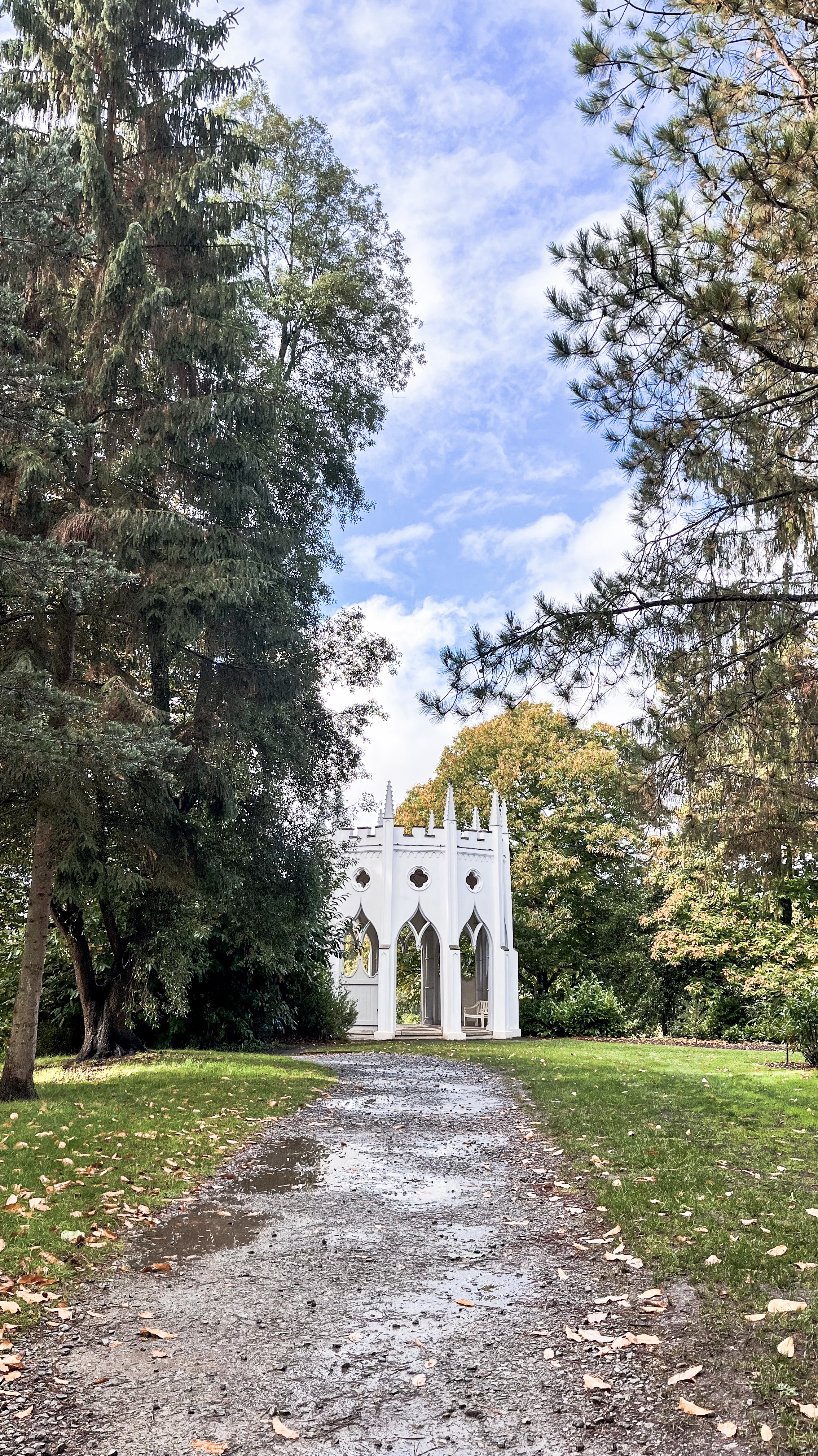 The Gothic Temple in Painshill Park, surrounded by trees on a sunny day.