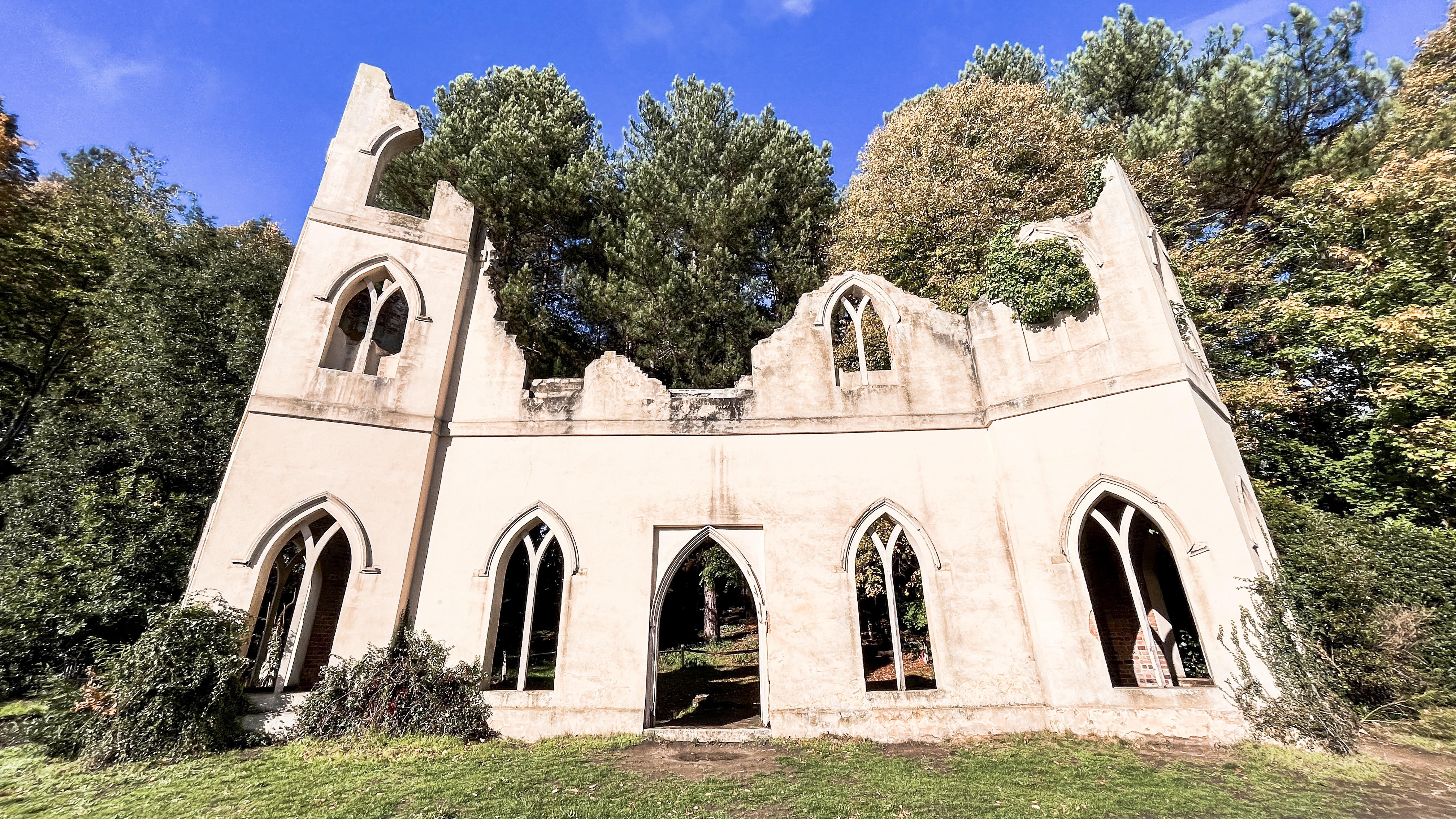 The Ruined Abbey beside the Serpentine Lake in Painshill Park on a Summer's day.