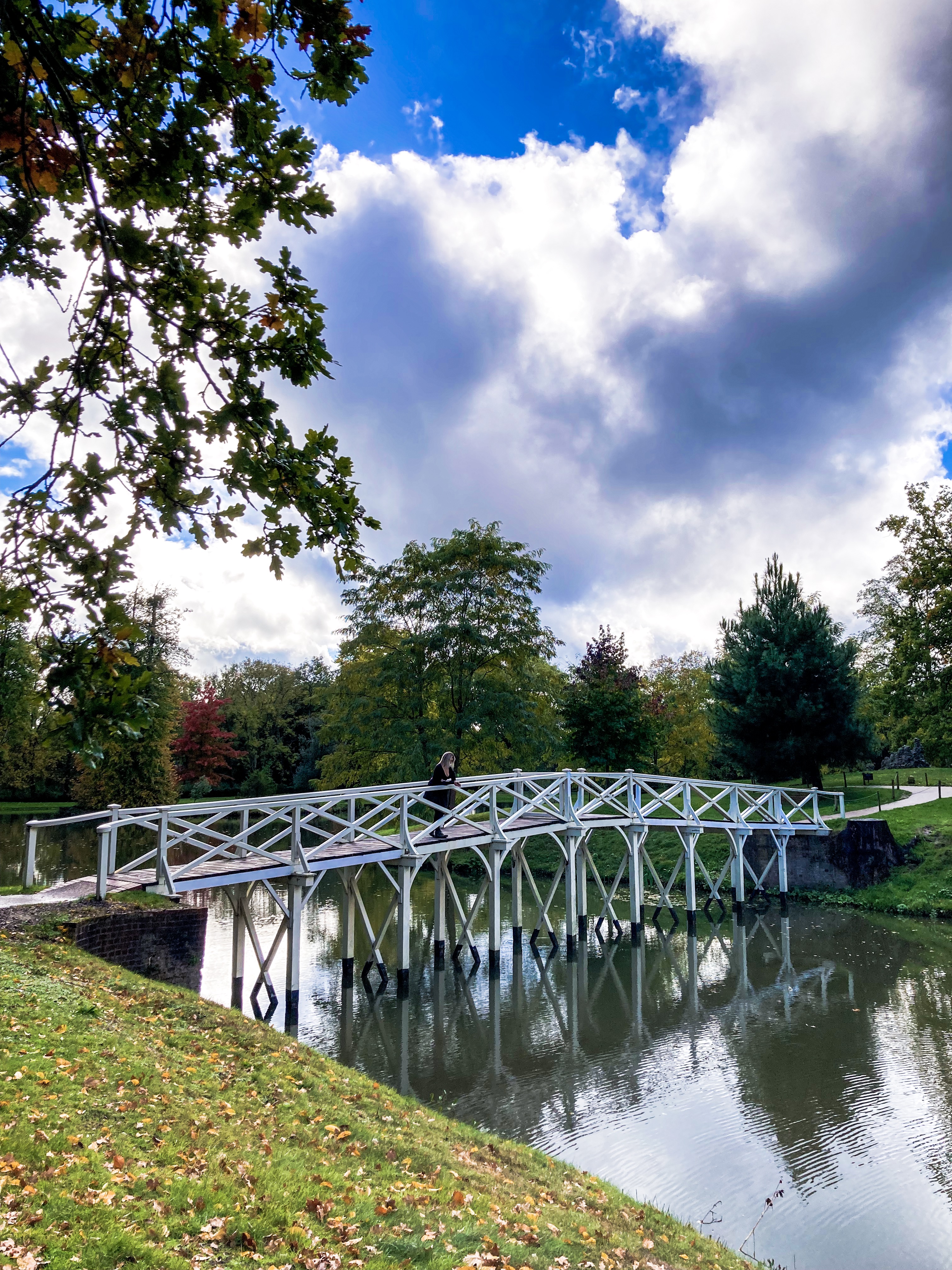 The Chinese Bridge over the Serpentine Lake at Painshill Park - an ornate whitewashed wooden bridge.