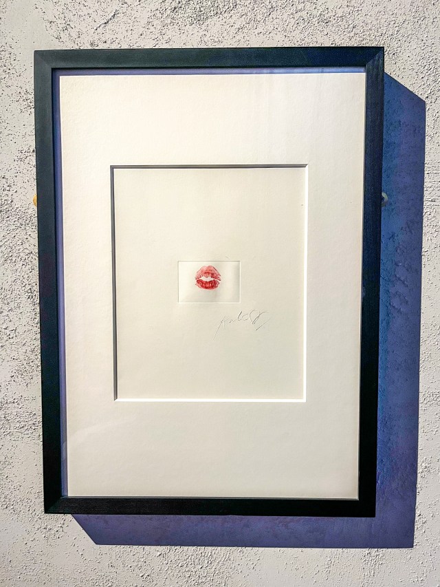 A framed lipstick print from the famous Kate Moss kiss, in the Cult of Beauty art exhibition at the Wellcome Collection, London